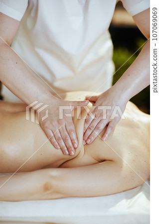 Closeup on medical massage therapist do therapeutic massage 107069069
