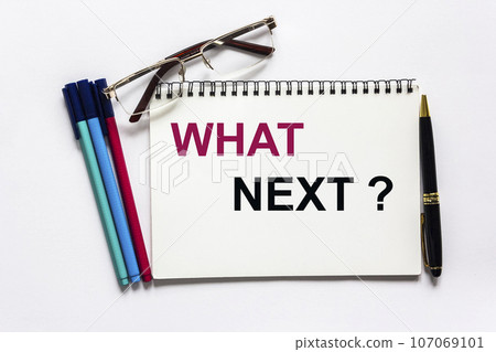 Text written on notepad What's Next, concept on a white background. Nearby are markers 107069101