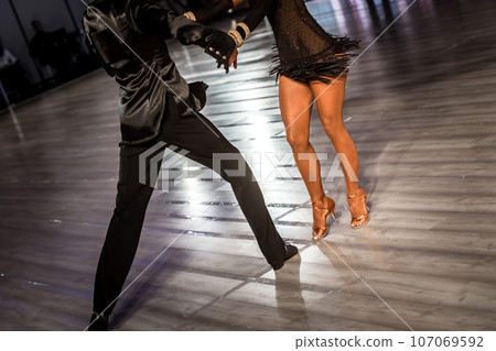a couple dance a Latin dance. the legs of a dancing couple 107069592