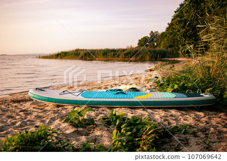 sup paddle board on the lake coast 107069642