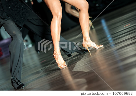 Legs of young dancers on the dance floor Legs of young dancers on the dance floor 107069692