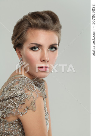 Beautiful woman face closeup portrait. Perfect model with makeup and jewelry earring  107069858