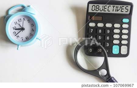 the text OBJECTIVE is written on the display of the calculator, next to a magnifying glass 107069967
