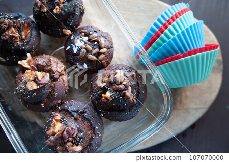 Freshly baked muffins , Cupcake molds . Homemade baking concept, top view. Freshly baked muffins , Cupcake molds . Homemade baking concept, top view. 107070000