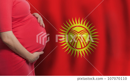 Kyrgyz pregnant woman belly on flag of Kyrgyzstan background 107070110