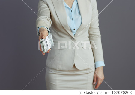 Closeup on female employee giving dollars money packs Closeup on female employee giving dollars money packs 107070268