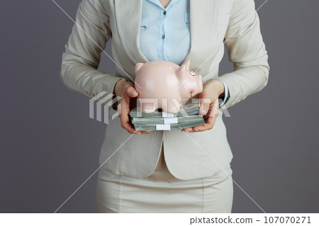 Elegant business owner woman in light business suit 107070271