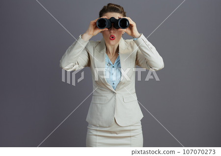 surprised elegant female employee in light business suit surprised elegant female employee in light business suit 107070273