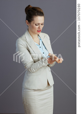 sad trendy small business owner woman in light business suit 107070280
