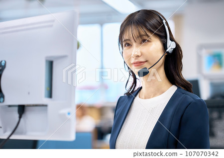 Smiling operator wearing a headset 107070342