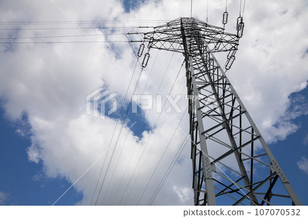 View from below of the tall poles of the high-voltage overhead line. View from below of the tall poles of the high-voltage overhead line. 107070532