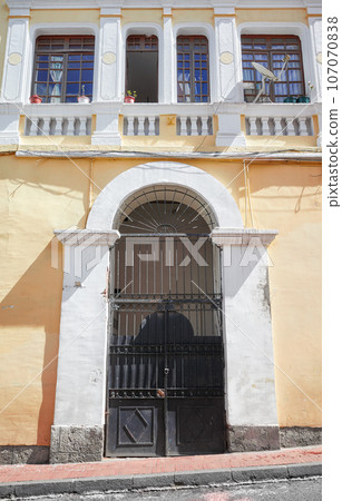 Street view of the facade of an old colonial building, Quito, Ecuador. 107070838