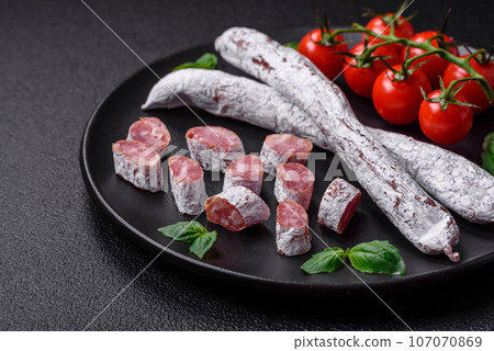 Delicious Spanish smoked sausage fuet with salt and spices Delicious Spanish smoked sausage fuet with salt and spices 107070869