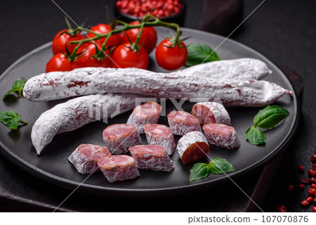 Delicious Spanish smoked sausage fuet with salt and spices Delicious Spanish smoked sausage fuet with salt and spices 107070876