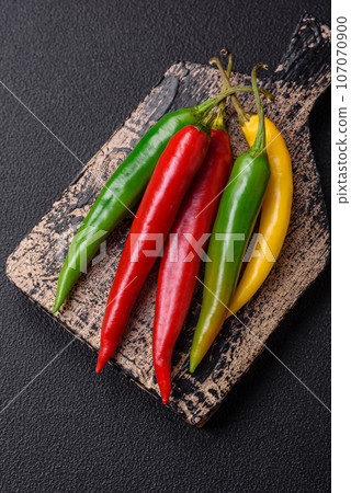Hot chili peppers of three different colors red, green and yellow Hot chili peppers of three different colors red, green and yellow 107070900