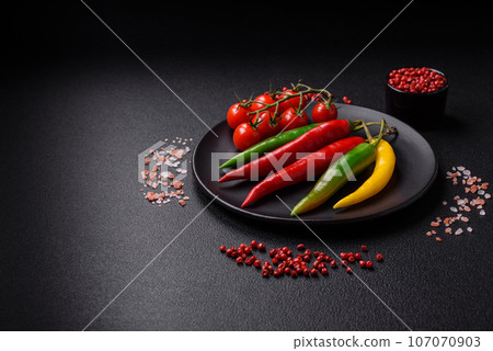 Hot chili peppers of three different colors red, green and yellow 107070903