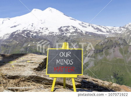 Our minds matter ourmindsmatter symbol. Concept words Our minds matter on beautiful black chalk blackboard. Beautiful mountain Elbrus background. Our minds matter ourmindsmatter concept. Copy space. 107071922
