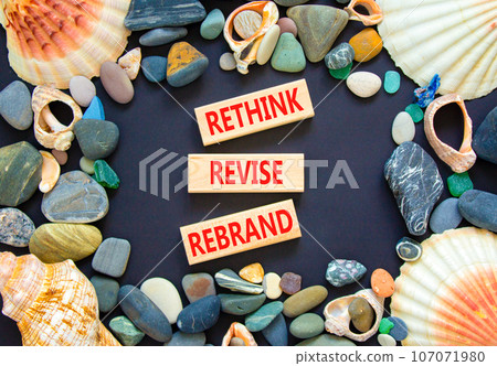 Rethink revise rebrand symbol. Concept word Rethink Revise Rebrand on beautiful block. Beautiful black table black background. Business brand motivational rethink revise rebrand concept. Copy space. 107071980