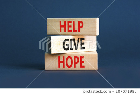 Help give hope symbol. Concept word Help give hope on beautiful wooden block. Beautiful grey table grey background. Business motivational help give hope concept. Copy space. Help give hope symbol. Concept word Help give hope on beautiful wooden block. Beautiful grey table grey background. Business motivational help give hope concept. Copy space. 107071983