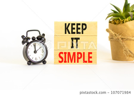 Keep it simple symbol. Concept word Keep it simple on beautiful wooden block. Black alarm clock. Beautiful white table white background. Business motivational keep it simple concept. Copy space. Keep it simple symbol. Concept word Keep it simple on beautiful wooden block. Black alarm clock. Beautiful white table white background. Business motivational keep it simple concept. Copy space. 107071984
