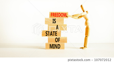 Freedom in mind symbol. Concept words Freedom is a state of mind on wooden block. Beautiful white table white background. Businessman icon. Business freedom is a state of mind concept. Freedom in mind symbol. Concept words Freedom is a state of mind on wooden block. Beautiful white table white background. Businessman icon. Business freedom is a state of mind concept. 107072012