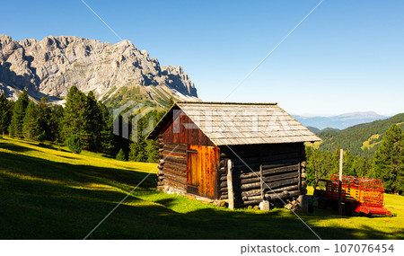 Wooden farm building on hillside in area Mont-de-Fornel, Dolomites. 107076454