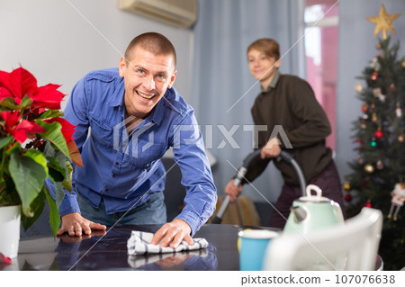 Father and son cleaning room together before christmas Father and son cleaning room together before christmas 107076638