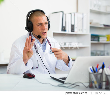 Doctor consulting patient online via laptop indoors. Telemedicine concept Doctor consulting patient online via laptop indoors. Telemedicine concept 107077129