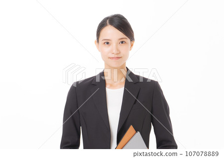 Smiling business woman holding a file Smiling business woman holding a file 107078889
