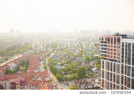 smog smoke over town. city panorama, street, townhouse, houses, buildings. smoke from summer forest fires, bad ecology 107080399