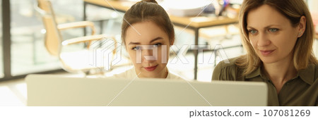 Boss and manager are looking at computer display in office. 107081269