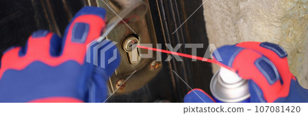 Door lock and handyman hands with spray balloon close up. 107081420