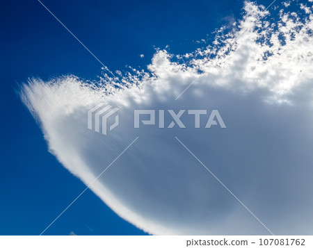 A large hanging cloud (lenticular cloud) shaped like an upside-down moon umbrella that forms in the sky far to the lee of Wakkanai Rishiri Island, Hokkaido. A large hanging cloud (lenticular cloud) shaped like an upside-down moon umbrella that forms in the sky far to the lee of Wakkanai Rishiri Island, Hokkaido. 107081762