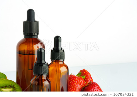 Electronic cigarette liquids with berry and kiwi flavor on white background Electronic cigarette liquids with berry and kiwi flavor on white background 107084321