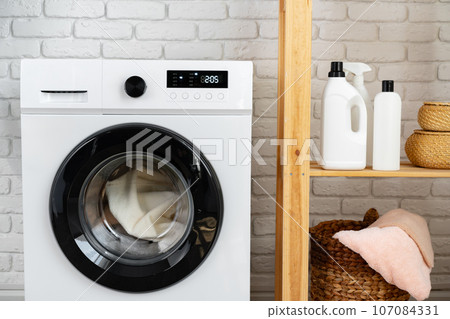 Modern white washing machine close up photo 107084331