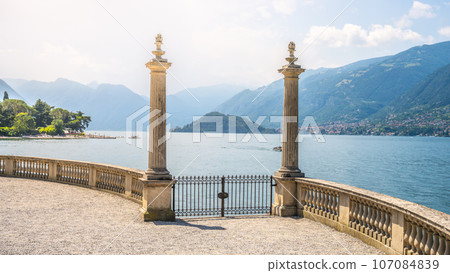 Ornamental gate with roman columns to Como Lake, Italian: Lago di Como, Bellagio, Lombardy, Italy 107084839