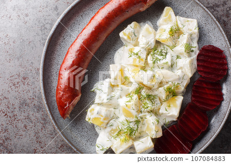 Swedish Lard Sausage Isterband with potatoes in cream sauce with dill and boiled beets close-up on a plate. Horizontal top view 107084883