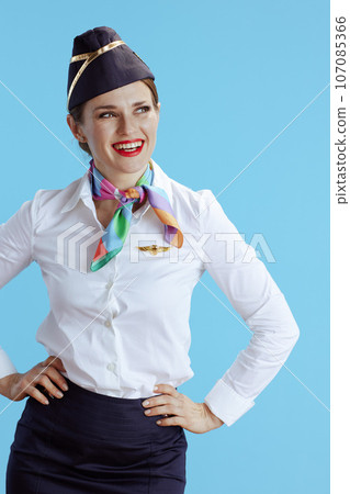 smiling modern female stewardess on blue looking aside 107085366