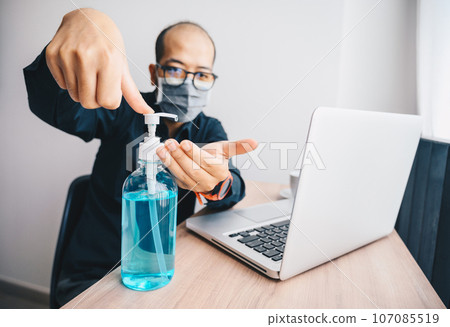 Businessman washing hand by using hand sanitizer. Hand sanitizer is Instant gel contains at least 60 % alcohol used to decrease infectious or kills germs, bacteria even more coronavirus. 107085519