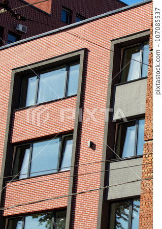 Windows of an old multistorey building Windows of an old multistorey building 107085537