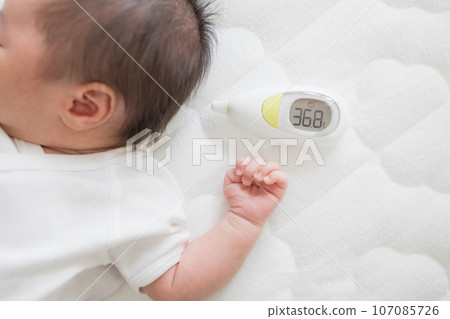 Newborn and thermometer Newborn and thermometer 107085726