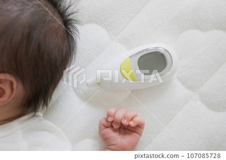 Newborn and thermometer Newborn and thermometer 107085728