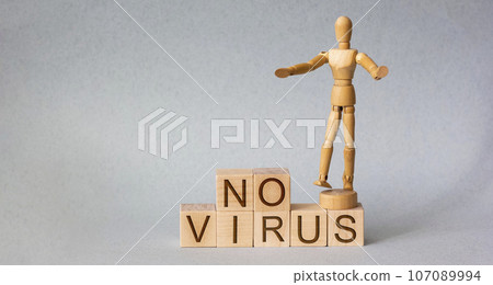 Wooden man with wooden block written no virus Wooden man with wooden block written no virus 107089994