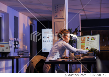 Executive manager preparing to leave corporate job, working late at night at company profit progress. Overworked businesswoman finishing financial growth report. Business concept Executive manager preparing to leave corporate job, working late at night at company profit progress. Overworked businesswoman finishing financial growth report. Business concept 107090142