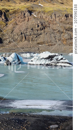 Diamond shaped Vatnajokull iceberg in Iceland with massive glacier lagoon, natural covered frost ice blocks. Icelandic glacial rocks creating frosty hills, wintry weather in iceland. 107090188