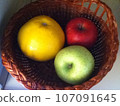 Round three colored fruits in a basket 107091645