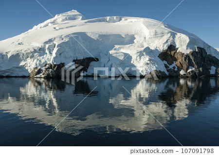 Lemaire strait coastal landscape, mountains and icebergs, Antarctic Peninsula, Antartica. 107091798
