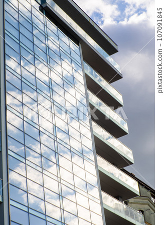Modern luxury residential building on sunny day with blue sky. Facade of a house 107091845