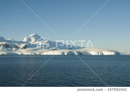 Lemaire strait coastal landscape, mountains and icebergs, Antarctic Peninsula, Antartica. 107092042