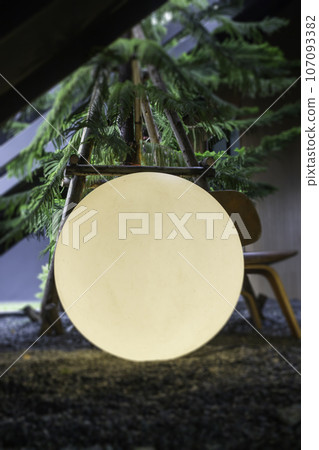 A bright glowing matte white burning round light bulb 107093382